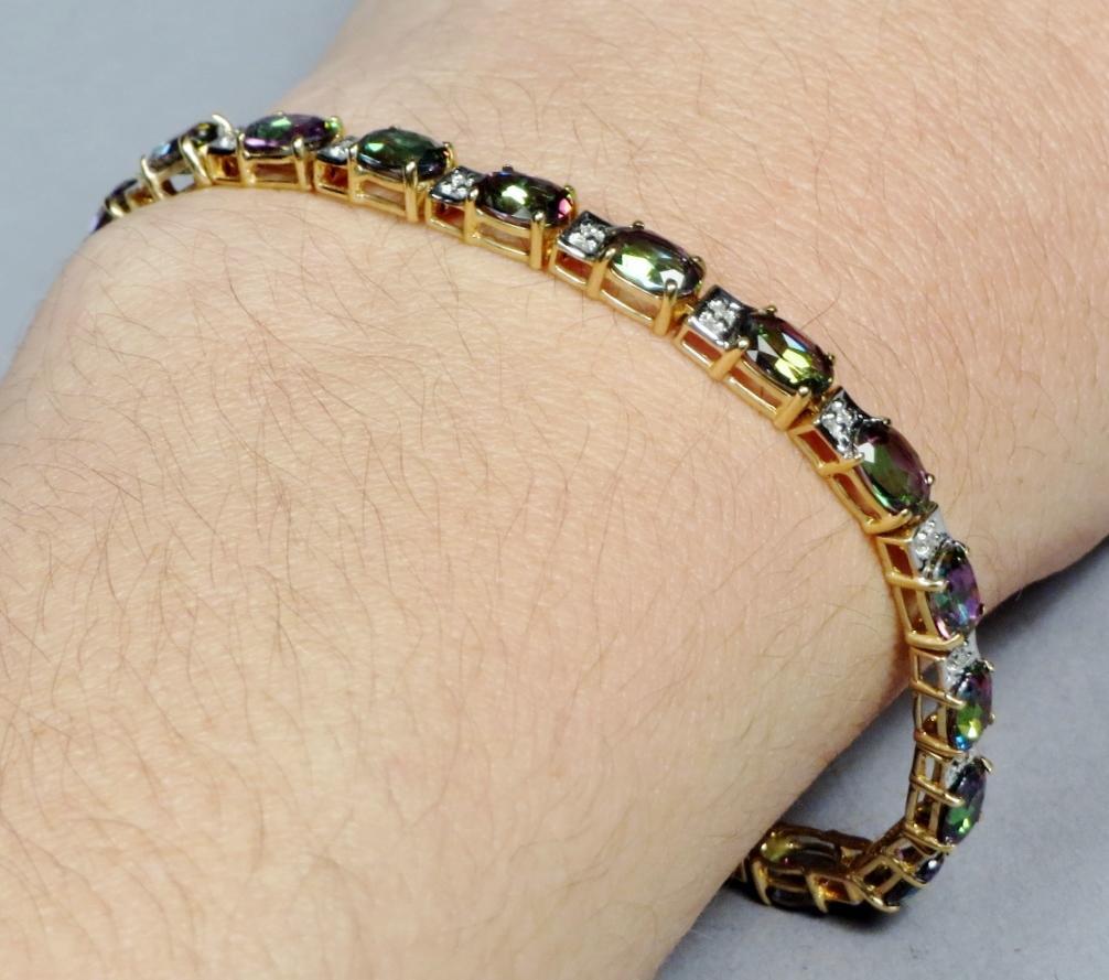 10K Yellow Gold Synthetic Alexanderite & Diamond: Lovely 10K yellow gold bracelet with oval cut synthetic Alexanderite and small single cut diamond accents, set in what appears to be white gold. Marked with the copyright symbol and 10K on one end of 