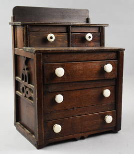 19th C. Salesman Sample Chest of Drawers: This wonderful 19th century chest of drawers is salesman sample sized. It appears entirely hand crafted with a pair of valet drawers on step back top and three lower drawers. Ornate carved inserts