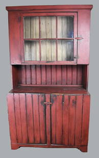 American Primitive Red Painted Step Back Cupboard: This beautiful piece is an antique primitive step back cupboard. Appears to be pine wood and painted red. Single glass upper door with single shelf and notches for hanging spoons. Lower doors