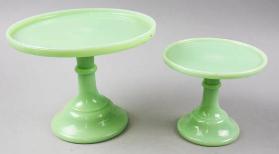 Pair Mosser Jadeite Pedestal Cake Stands: Both of these pretty cake stands are attributed to Mosser Glass Company. Molded jadeite glass and measure 5.5&#34; tall x 6.5&#34; across and 7&#34; tall x 9.5&#34; across