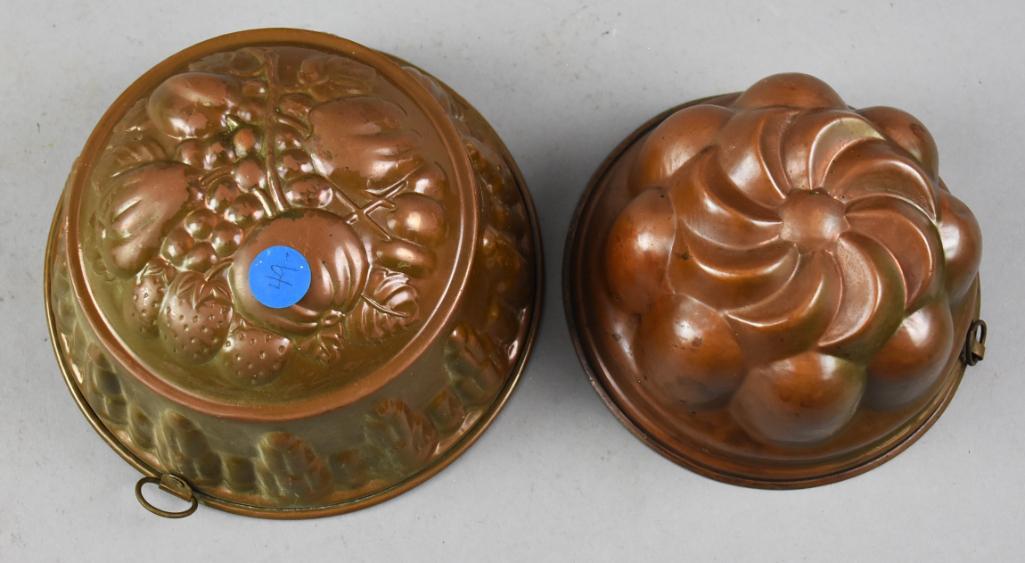 Primitive Antique Copper Jelly or Mousse Molds, Kreamer: Pretty pair of copper jelly or mousse molds. Primitive antiques with one being stamped Kreamer with fruit as the main decor and architectural details on the sides. The other is unmarked with flower mo