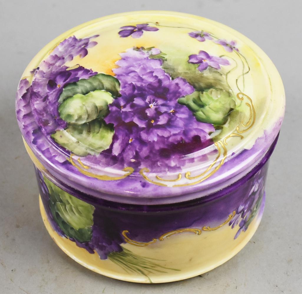c1900 Limoges D&C Porcelain Dresser Box: Beautiful porcelain dresser box is Limoges. Hand painted with purple pansies on a yellow base color with green. It is marked on the bottom D&C (Delinieres & Co) France. Measures approx 4.5" tall x 6"