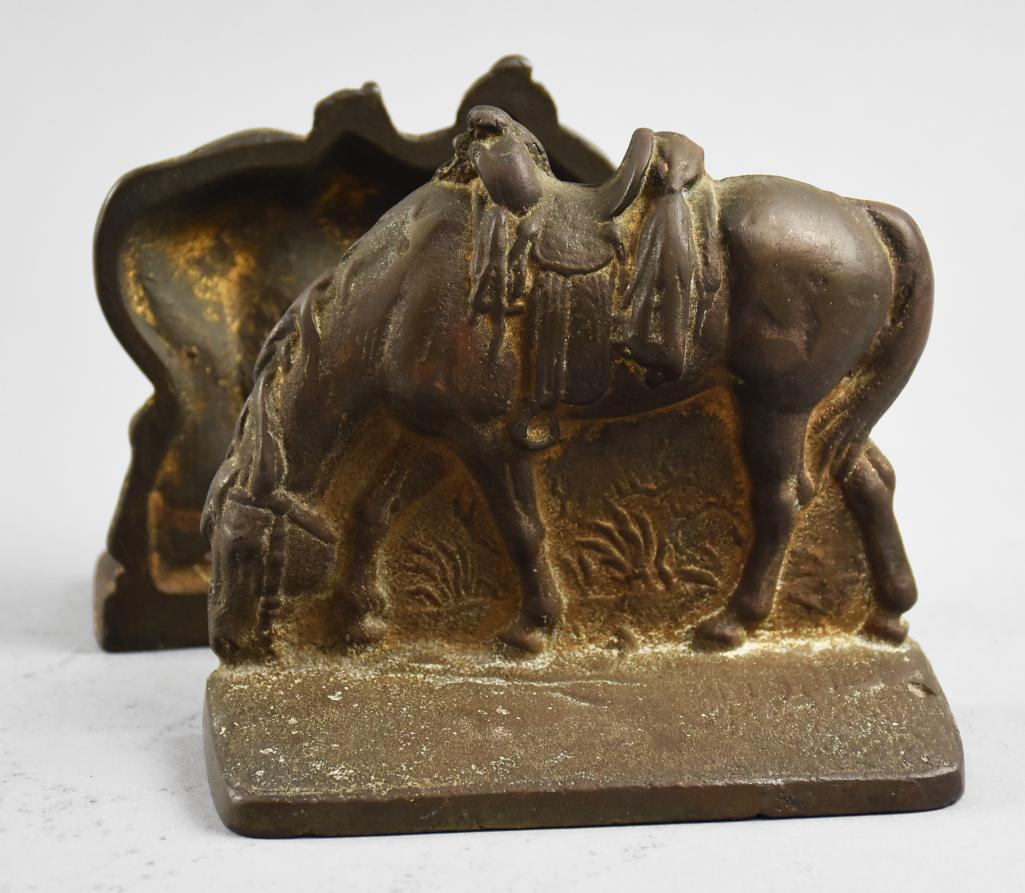 Vintage Cast Grazing Horses Bookends: This great pair of bookends appear to be cast iron in the form of riderless grazing horses. They are unmarked and measure 5 tall x 5.5 wide.