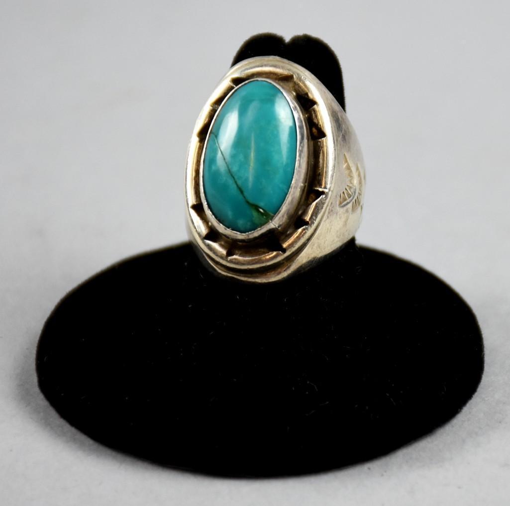 Dean Brown Signed Navajo Sterling & Turquoise Ring: This beautiful ring is sterling and turquoise and is Navajo in origin. It is signed DB for Dean Brown, Navajo. Approx weight 16.4g and approx size 6 1/2.There is a crack in the turquoise.