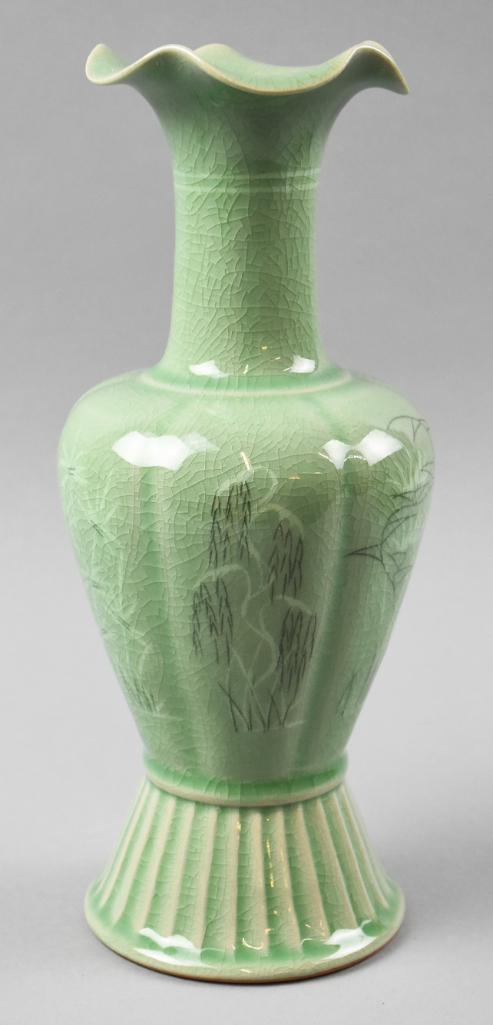 Korean Celadon Crackle Glaze Vase, Signed: This is a wonderful celadon crackle glaze vase with foliate design. Flare footed base has a signature underneath and stands 11.5" tall. Appears to be of Korean origin.