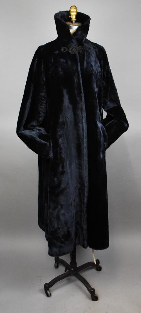 Vintage Synthetic Fur & Silk Opera Coat: This stunning opera coat is black synthetic fur with pure silk lining. Full length with high collar and soutache style closure at the neckline. Only label is 100% Pure Silk, with the silk lining with 