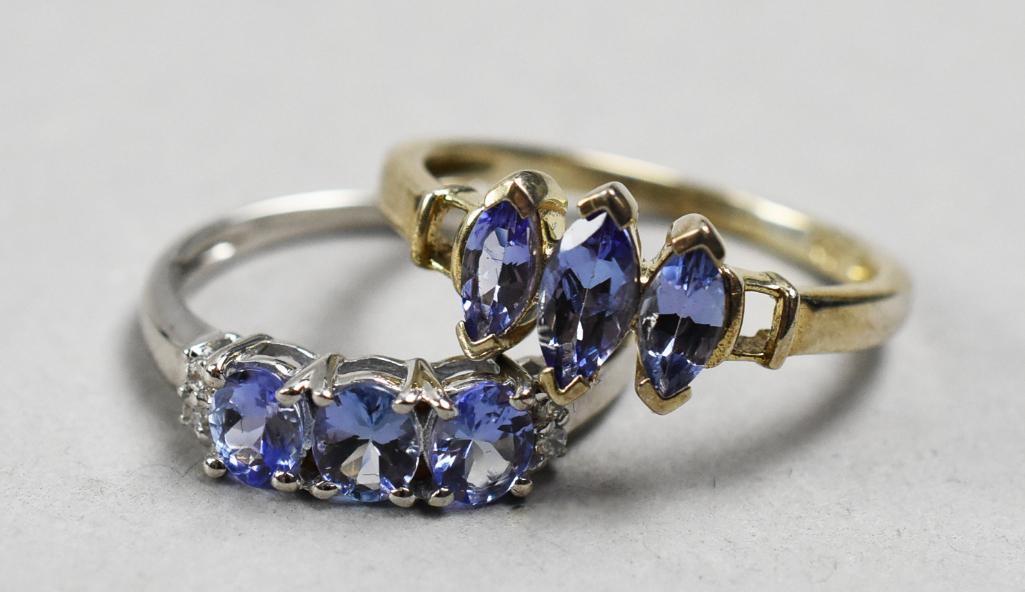 Pair Sterling Tanzanite Topaz Stone Rings w/ GLA Appraisals: 2 Sterling Tanzanite gemstone Rings w/ GLA Appraisals. Stamped 925. Marquise cut ring is size 8.5, 1ctw, platinum/silver setting. Oval cut is size 7, 3 oval stones, .92ctw w/ white topaz accents, plat