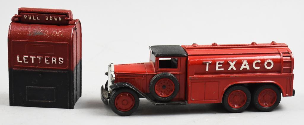 Vintage Ertl Fuel Tanker & Antique Cast Still Bank Lot: Nice lot for the bank collector is the 2 1/2 ton Diamond Fuel Tanker from Ertl, 1990 and a standing mail box in cast iron, unknown maker. Measure from 4" and 2.5" tall