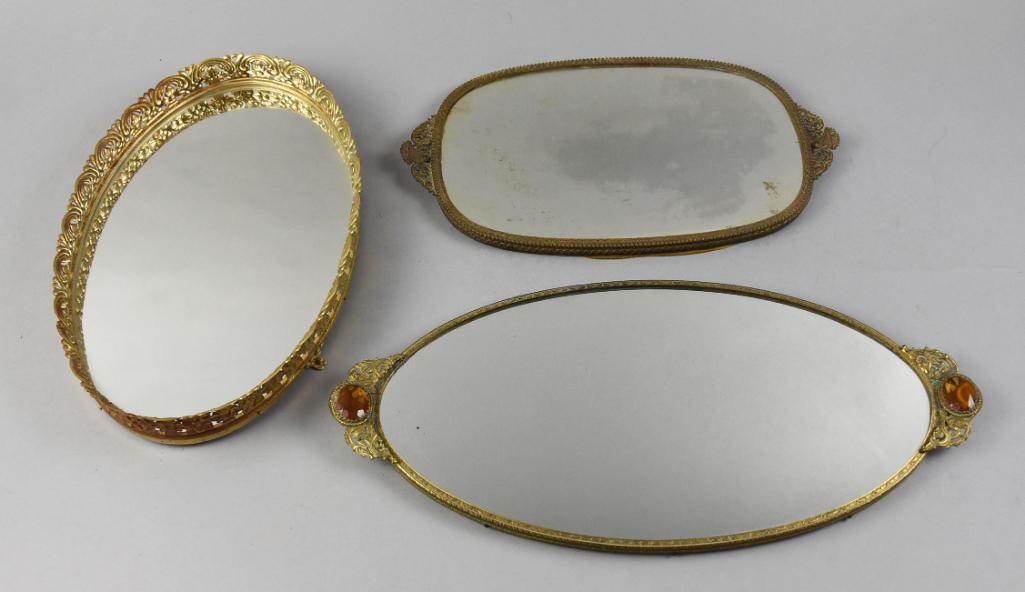 MCM Brass Perfume Vanity/Dresser Mirrors: These great mirrors are all vintage and are either brass or have a pretty brass finish. One is footed, another has amber "jewels". Measure from 8" x 13" to 8" x 17" and are unmarked