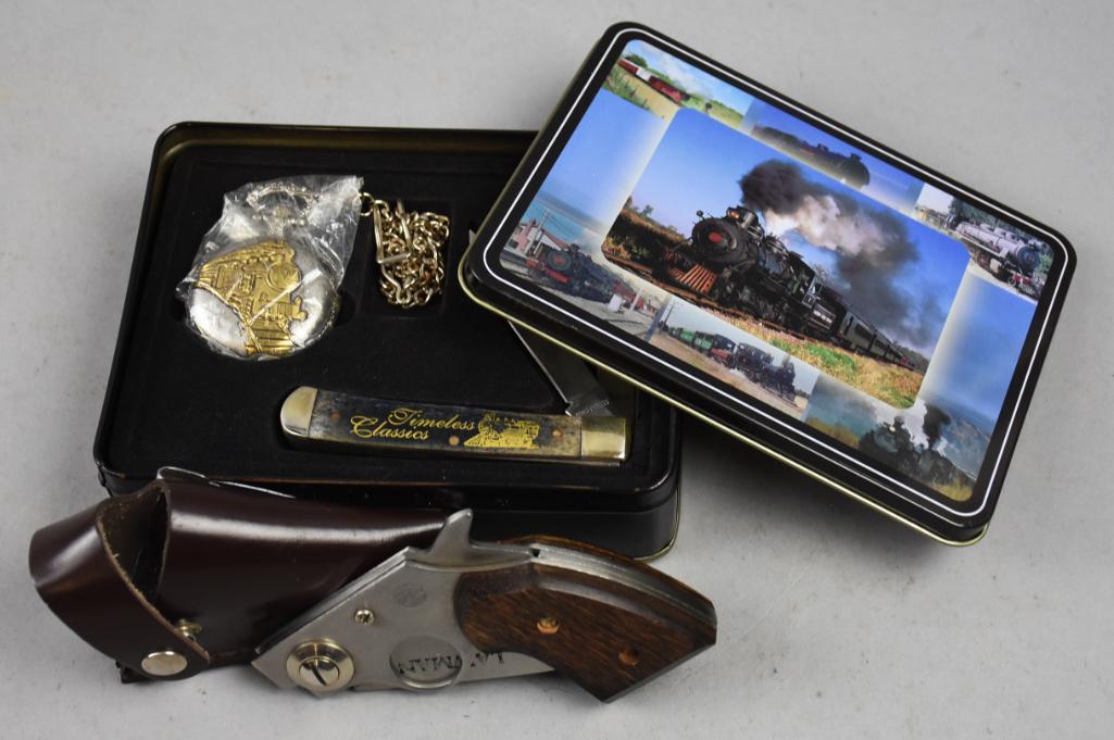 United Cutlery Lawman Gun Knife, Timeless Classics Tin: Fun lot of collectible pocket knives. One is marked "Lawman" by United Cutlery with gun grip and holster. The tin from Timeless Classics with a railroad themed pocket watch and a Frost Cutlery poc