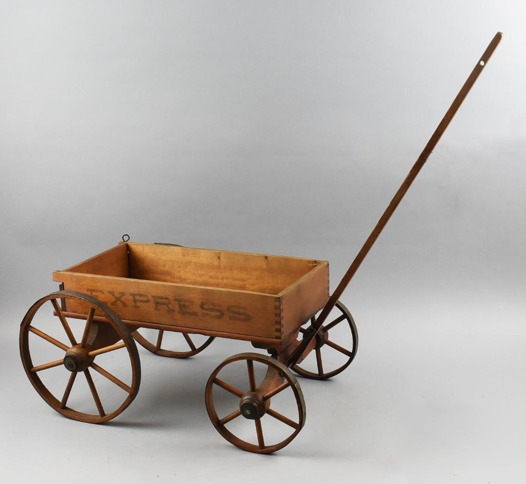 Primitive Antique Wooden Express Toy Wagon: Great looking antique solid wood toy wagon. Sides are stenciled with EXPRESS, back gate opens, with pin lock mechanism. Two different size spoked wheels with steel overlay. Handle appears original. Be