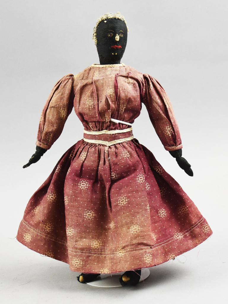 Primitive Antique Black Americana Cloth Doll: Darling little girl is a hand crafted Black Americana cloth doll with hand embroidered facial features, She wears what appears to be a head scarf and a red cotton dress with slip and stocking feet. Sh
