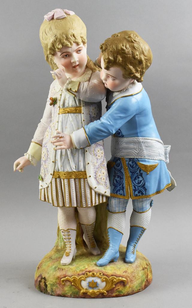 Victorian French Depose Bisque Boy and Girl Figurine Large: This is a precious little boy and girl figurine that is French bisque. One piece with a boy standing behind a young girl. Hand painted with great detail giving texture and life. All accented by gold p