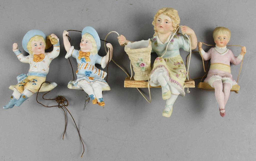 Vintage & Antique German & Japan Bisque Children on Swings: These are cute little bisque figurines on swings. The pair with blue hats are of German origin with one having a lightly impressed mark on bottom. The girl with basket is marked with crossed arrows, t