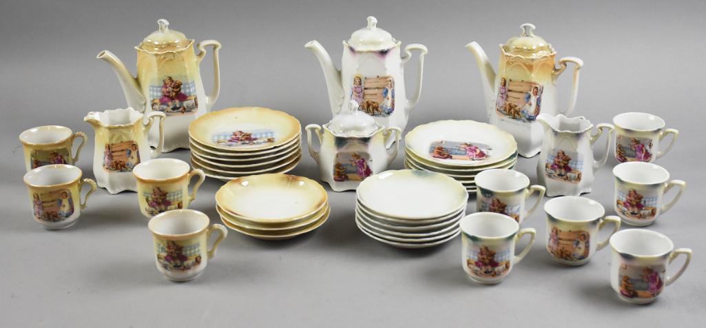 c1880 German Porcelain Child Porcelain Tea Sets: These are two different sets of German porcelain tea sets for dolls or children. Each has the same transfer pattern with one having yellow luster with six plates, three saucers, four cups, teapot, sug