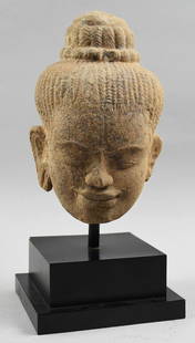 11th-13th Century Sandstone Buddha Bust, Baphuon , COA: This is a wonderful Buddha bust with custom stand. It comes with documentation showing that it is Sandstone and is from the Baphuon Period, Cambodia. Head is looking downward and has a subtle smile.