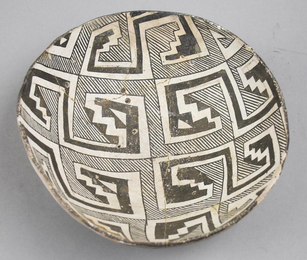 950-1100 AD Anasazi Reserve Black on White Bowl: This great bowl is of Anasazi culture dating 950-1100 AD. Reserve black lines, stair steps and square coils on white.the holes you see are period holes drilled by hand. The bowl probably broke during 