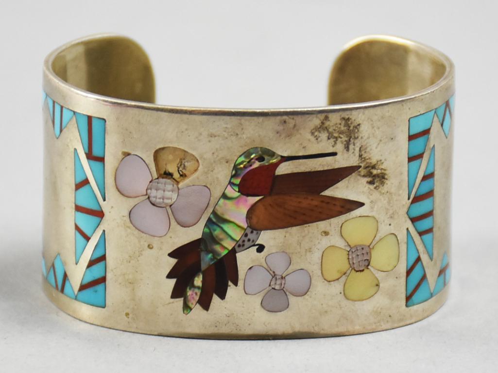 Vintage Albert & Dolly Banteah, Zuni Sterling Hummingbird Cuff: This amazing sterling bracelet was designed by Zuni jewelry artists Albert and Dolly Banteah. It is inlaid with turquoise, coral and abalone in the form of a hummingbird. Well marked on inside with an