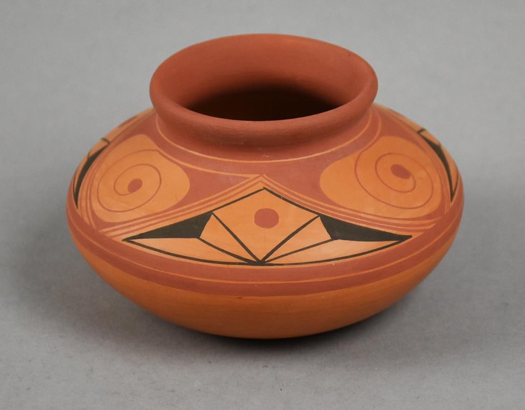 Quibor Lara Venezuela Pottery Hand Painted Vase: This beautiful piece of pottery is from Quibor Lara Venezuela. Red clay with hand painted swirls and geometric shape. There is also a signature on bottom, illegible. Measures approx. 2.5" tall x 4" wi