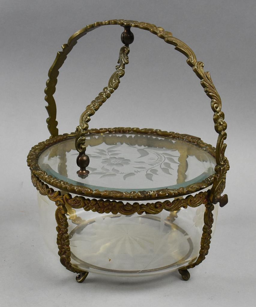 Antique French Dore Bronze Covered Crystal Basket: Beautiful basket appears to be of French origin. Dore bronze frame with C scrolls and flowers. Crystal bowl is etch cut with flower and stems. Cover lifts using the frame as handle. No visible marking