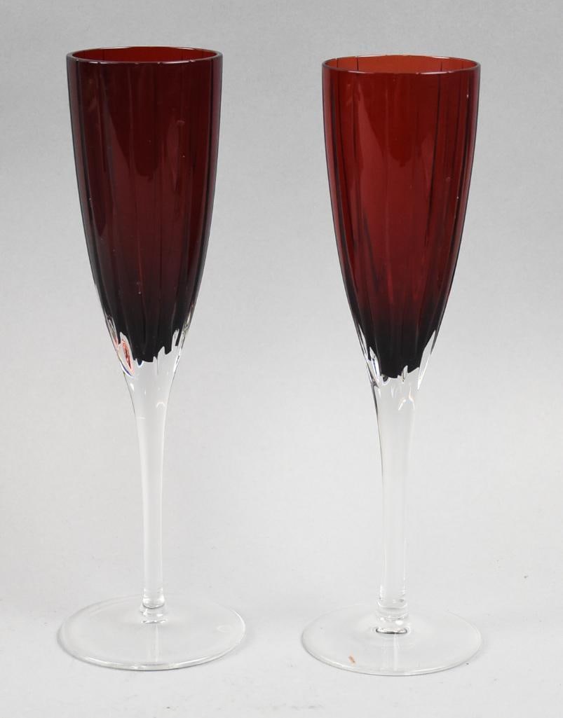 Faberge Rouge d'Orient Crystal Wine Glasses: Pretty pair of wine glasses from Faberge in the Rouge d'Orient pattern. Each is ruby with clear stem and acid marked on bottom. Stand approx. 9" tall. Pattern introduced and discontinued in 2009.
