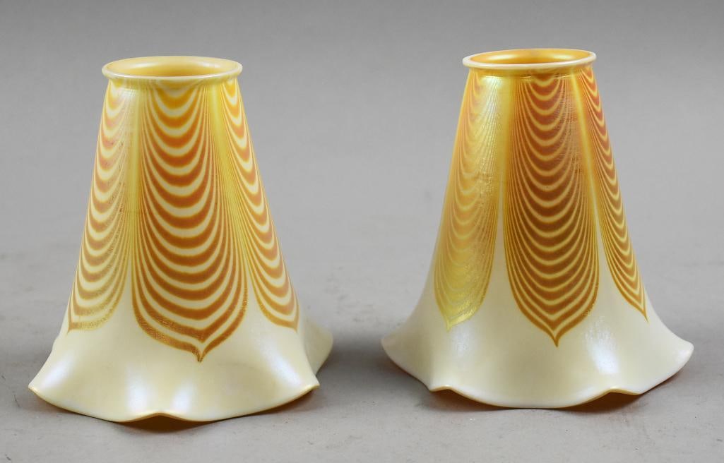 Steuben Attrib Draped Feather Art Glass Shades: This wonderful pair of glass shades are attributed to Steuben. The design is draped and pulled feather. The inside is iridescent orange both approx. 5.5" tall x 5.25" wide, fitters measure 2.25".