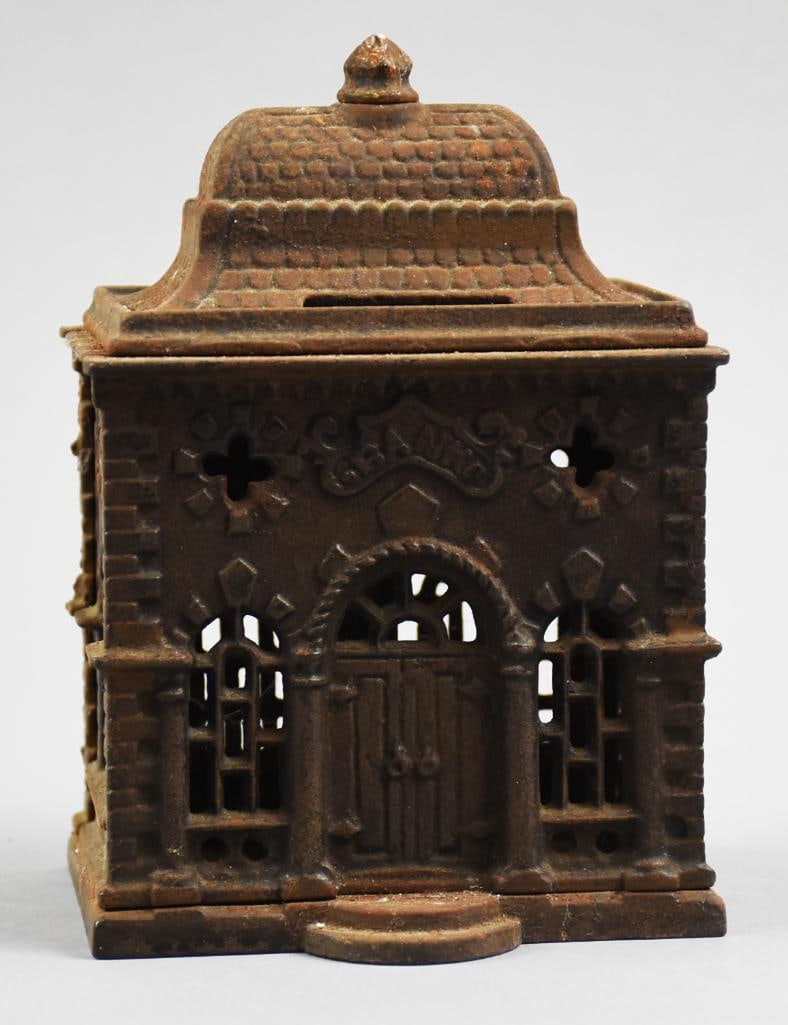 c1885 J&E Stevens Cast Iron Roof/Home Bank: This is a great looking antique bank from J&E Stevens.? Still bank has a roof coin slot and is pierced throughout so you can see your savings grow.? Only mark is the word BANK over the house doorway.?