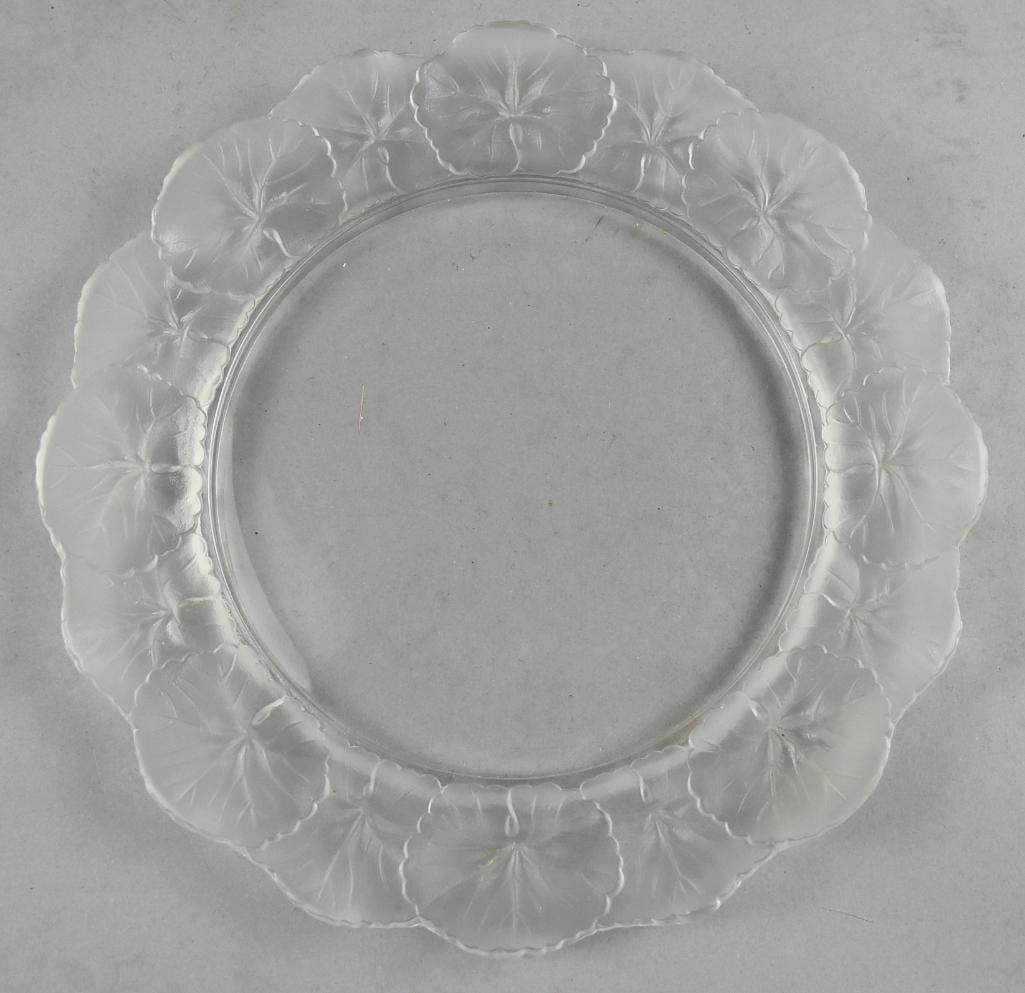 1945-2021 Lalique Honfleur 11" Dinner Plate: Lovely Lalique crystal plate that was produced from 1945-2021. The pattern is Honfleur?with flowers around the rim. Signed on the bottom and measures approx. 11" across.
