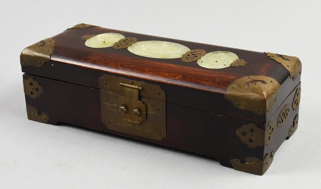 Vintage Chinese Rosewood w/ Jade Inlaid Jewelry Box: Gorgeous jewelry box is Chinese in origin. Wood appears to be rosewood, lid is inlaid with carved pierced jade and brass fittings. Brass hinges and lock plate are nicely etched. Inside is line with wh