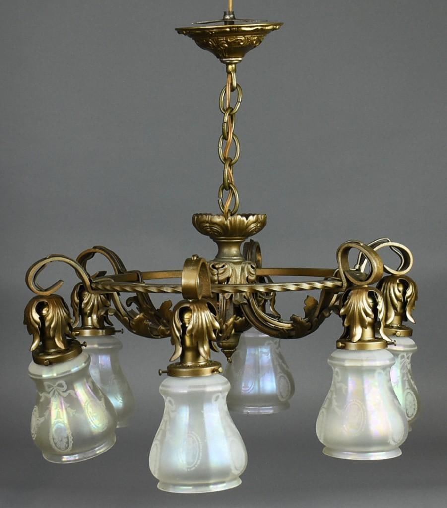 Art Nouveau Brass Ceiling Light w/ Iridescent Shades: Beautiful antique hanging light fixture. Six lights with twisted brass frame, scrolls and acanthus leaves. Shades are iridescent frosted with etched ribbons and flower urns. No visible marks and measu