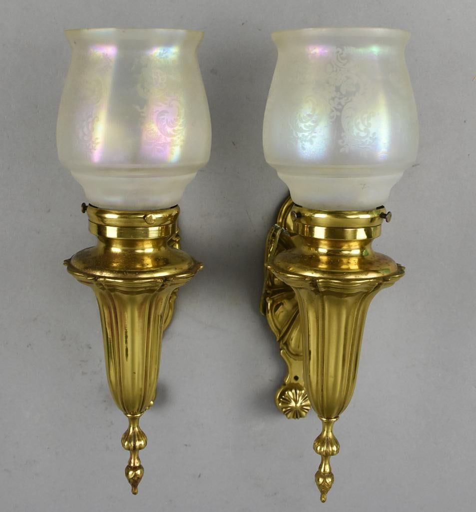Art Nouveau Brass Wall Sconce w/ Iridescent Shades: This stunning pair of Art Nouveau wall sconces. They are brass with ornate holders and back plate. Shades are frosted iridescent with etched flowers and scrolls. Visible mark of patented date December