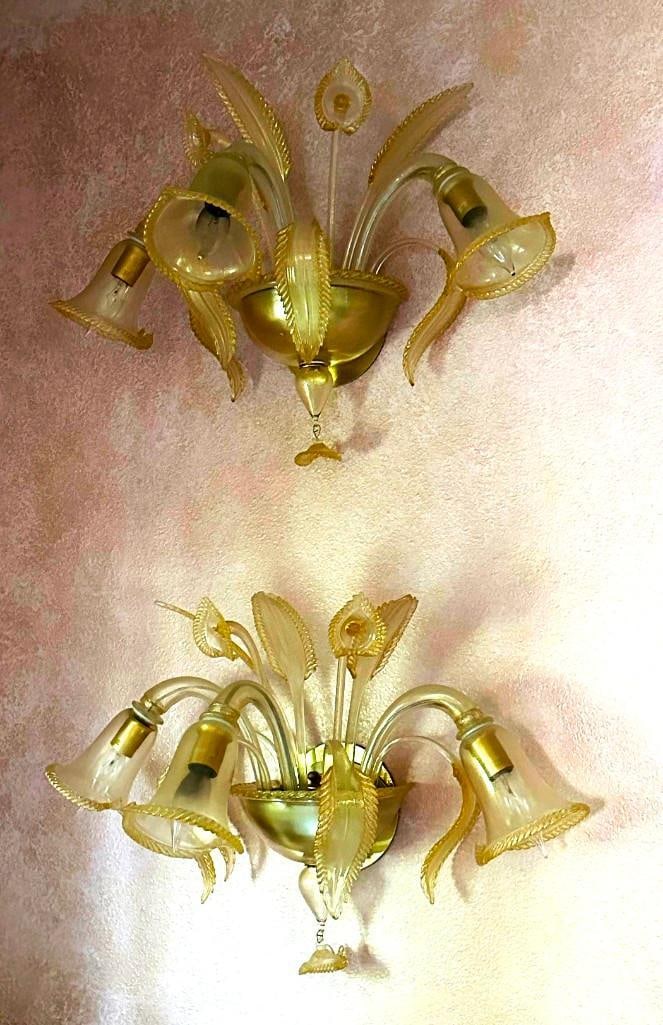 La Murrina Murano Glass Lilies w/ Gold Wall Sconces: Lovely pair of Venetian Murano wall sconces with flowers. Each appear to be lilies with leaves and tear drop center and dangling flower. Appear to be a set and match lot 234 and 235. Both measure appr