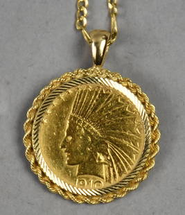 1910 $10 Indian Head Gold Coin Necklace: Beautiful $10 Indian Head coin in gold has been converted to a necklace. Coin is wrapped in a 14K yellow gold rope bezel and hangs from a 14K gold figaro chain. Necklace is approx. 23" long, coin