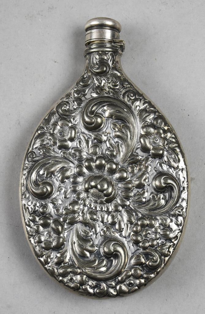 Antique Derby Silver Repousse Victorian Flask: Beautiful Victorian flask from Derby Silver with hinged cap. Plated silver repousse of flowers and scrolls. Marked along the side with mfg and 43. 7.5" x 4.5"