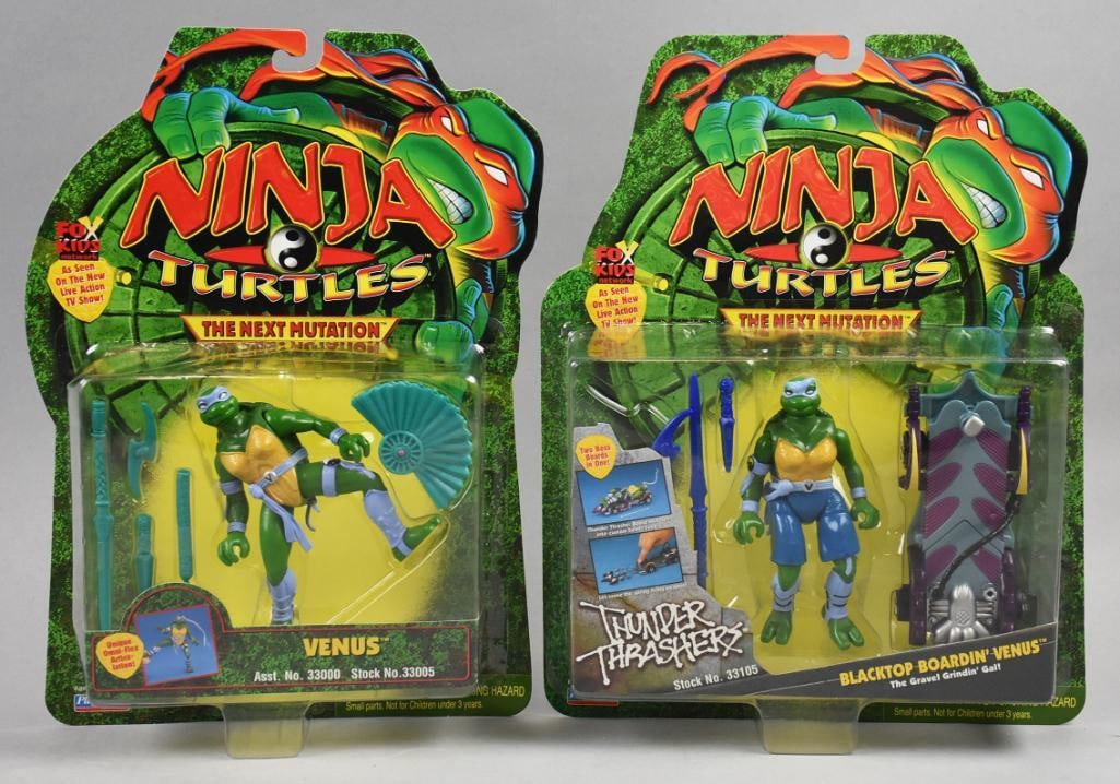 (2) 1997 Playmates Ninja Turtles Next Mutation-MOC-NOS: Pair of 1997 Playmates Ninja Turtles Next Mutation-MOC-NOS. Venus and Blacktop Boardin' Venus. Single owner collection from the largest toy collector on the West Coast.