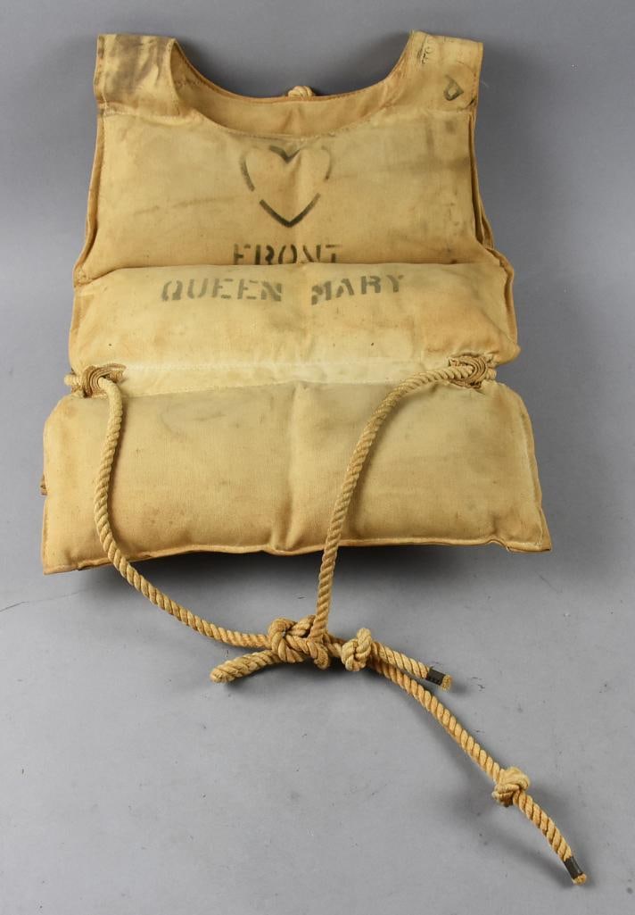 WWII Era Queen Mary Troopship Life Vest: This is an amazing piece of history from the famous RMS Queen Mary from the famous Cunard-White Star Line. During WWII, she was used as a troopship along with her sister ships, carrying New Zealand an