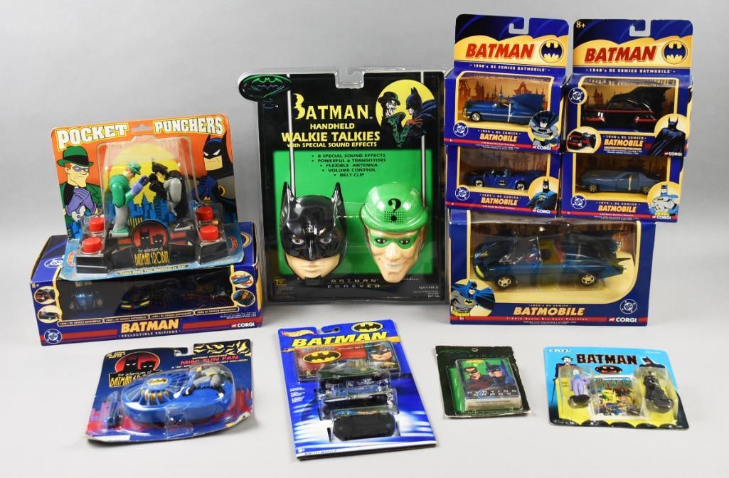 (12) 1990, 95, 2003-05 Various Mfg Batman Toy Asst-NOS: Lot is 1990, 95, 2003-05 Various Mfg Batman Toy Asst-NOS. Includes Batman Walkie Talkies, Mattel Hot Wheels, five Corgi Batmobiles (variants), Mini Fun Fan, Playing Cards, Ertl Die Cast figurines, Cor