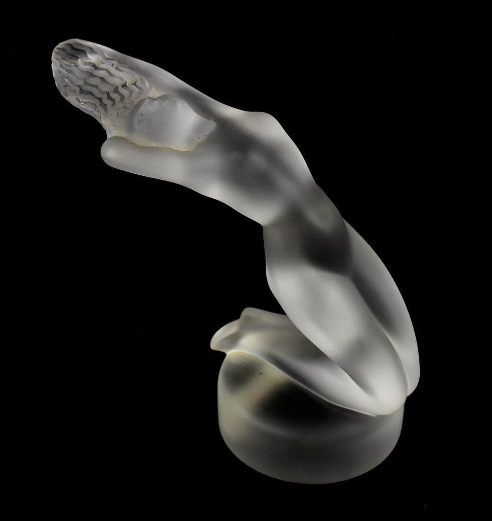 Lalique Chrysis Frosted Crystal Hood Ornaments: This is a beautiful Lalique crystal hood ornament. Frosted crystal in the form of a nude woman reclining backwards. Well marked on the bottom and retains original sticker. Measures approx. 5" tall x 6