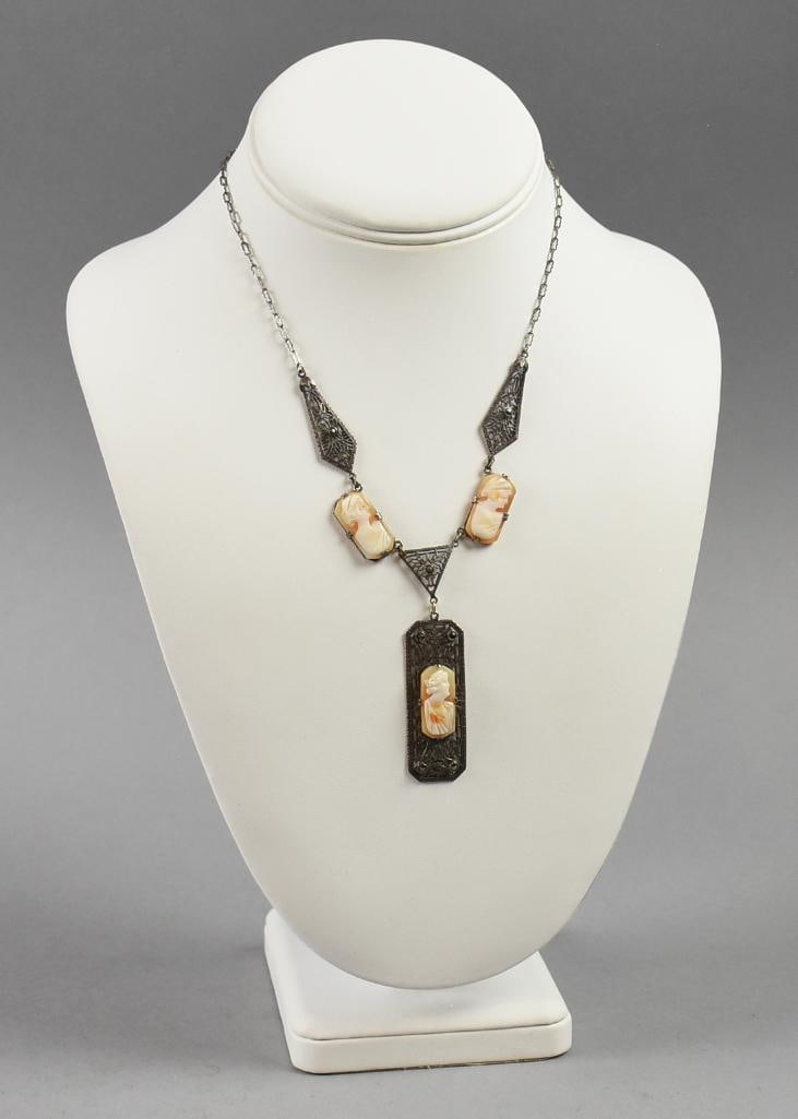 Vintage Art Deco Sterling & Carved Shell Cameo Necklace: This fabulous necklace is in sterling silver. Dainty chain with filigree stations, each with marcasite and carved shell cameo link. Pendant has marcasite and stamped on back STERLING. Measures approx.