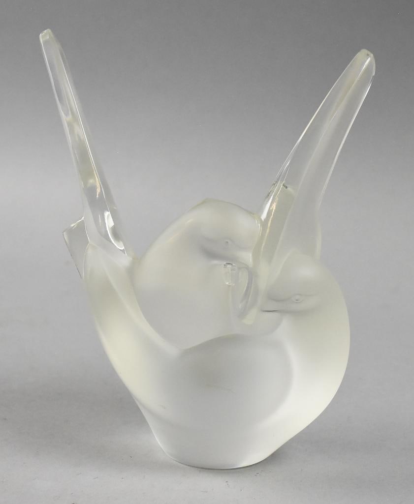 Lalique Sylvie Frosted Crystal Lovebirds Vase: Lovely piece of Lalique crystal. It is called Sylvie in the form of loving doves or lovebirds. Retains what appears to be the original flower frog and original label still in place. It is signed on bo