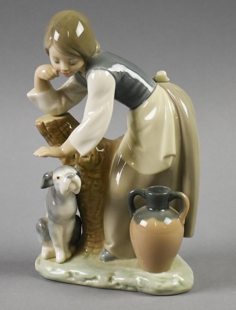 1972 Lladro Caress & Rest Porcelain Figural Grouping-Retired: Very sweet porcelain figural grouping from Lladro. It is called Caress and Rest with a young woman leaning on a tree stump petting a dog. It is numbered 1246 and retired in 1989. Measures approx. 8" t