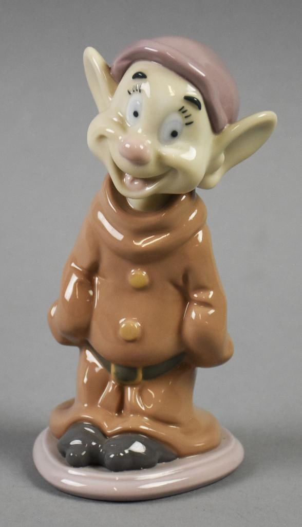 2018 Lladro Disney's Dopey Figurine-Signed: This sweet little fella is Dopey from Snow White and made by Lladro. It is signed on the bottom with what appears to be the sculptor Eva Marie Cuerva. Measures approx. 6" tall x 3" wide.