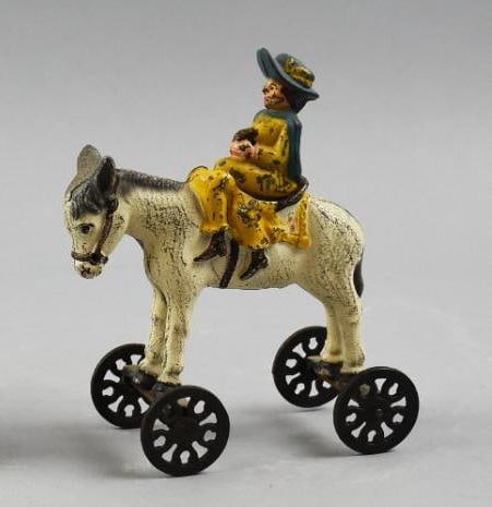 c1900 US Hardware Co. Victorian Cast Iron Girl on Donkey Pull Toy: Great antique toy is from US Hardware Co. which was only in operation from 1896-1901. Material is cast iron in the form of a donkey and a female rider sitting side saddle. No visible marks and measure