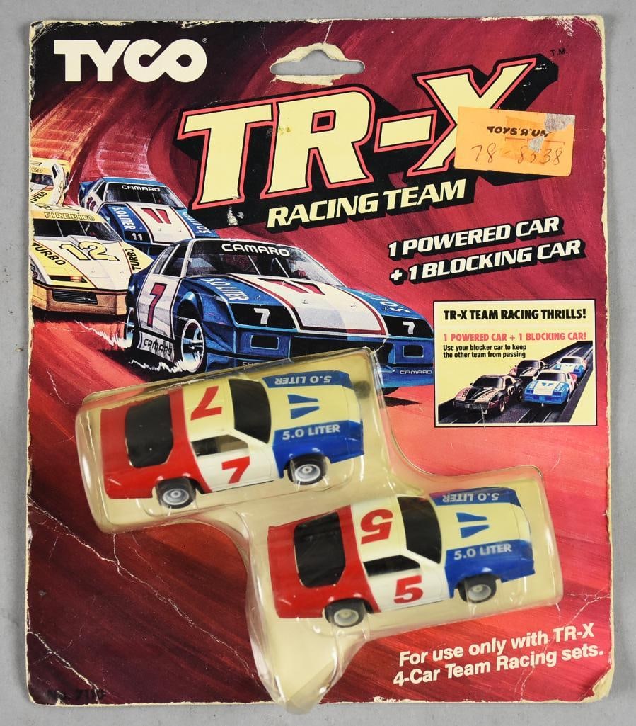 1985 Slot Cars Tyco TR-X Racing Team Slot Cars-Two Pack-MOC-NOS: 1985 Tyco TR-X Racing Team Slot Cars-Two Pack-MOC-NOS. Pack is one Camaro Powered Car and one Camaro Blocking Car. Single owner collection from the largest toy collector on the West Coast.
