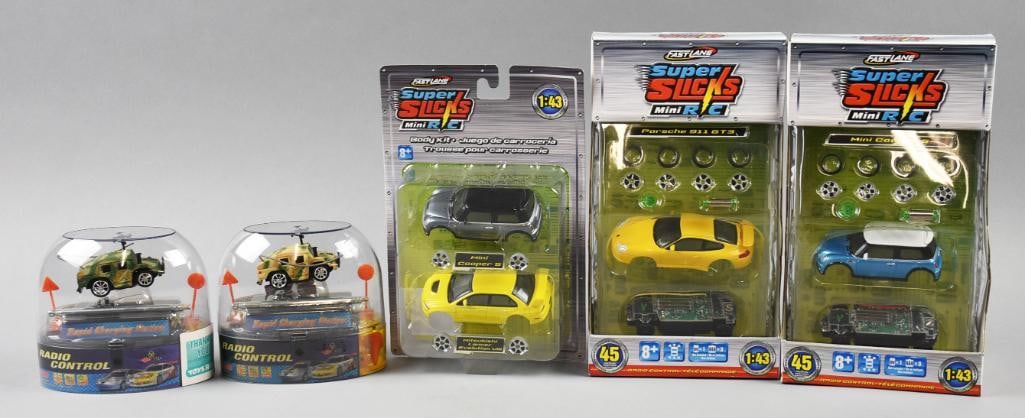 (5) 2001 Fast Lane Super Slicks & Radio Control-MIP-NOS: Lot is five 2001 Fast Lane Super Slicks & Radio Control-MIP-NOS. Includes Mini Cooper/Mitsubishi Lancer, Porsche, Mini Cooper, two Radio Control Mini Humvee (variant). Single owner collection from the