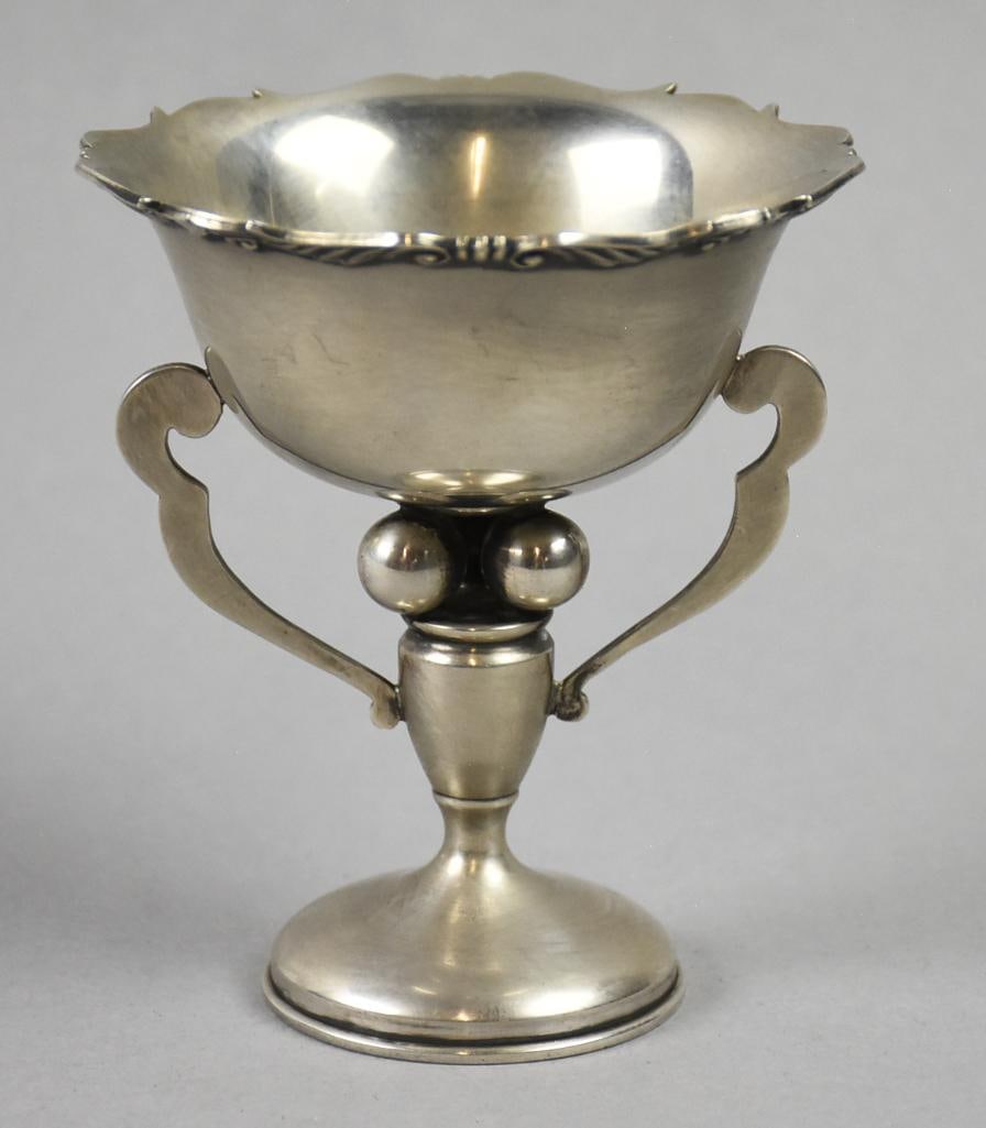 Antique Chinese Export Sterling Handled Wine Goblet: This beautiful piece is a Chinese export. Wine goblet with scalloped rim with a wing detail on the under side. Handles are flat and a squat pedestal base, base appears and feels hollow. It is stamped