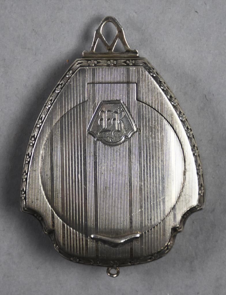 Art Deco The Thomae Co Sterling Pendant Compact: This darling piece is from American silversmiths The Thomae Co (founded in 1920). Classic Art Deco, crest shape with pinstripes on front and back accented by a floral border. Front monogram appea