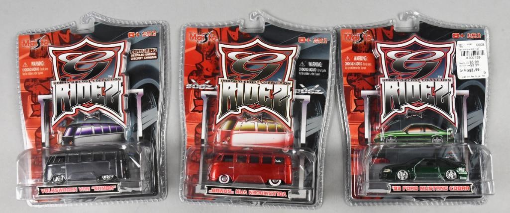 (3) 2006 Maisto G Rides Volkswagen/Mustang-Error-MOC-NOS: Lot is three 2006 Maisto G Rides Volkswagen/Mustang-Error-MOC-NOS. Includes on 1993 Ford Mustang Cobra and two Volkswagen "Samba" (variants) with the red bus having the name flipped upside down on the