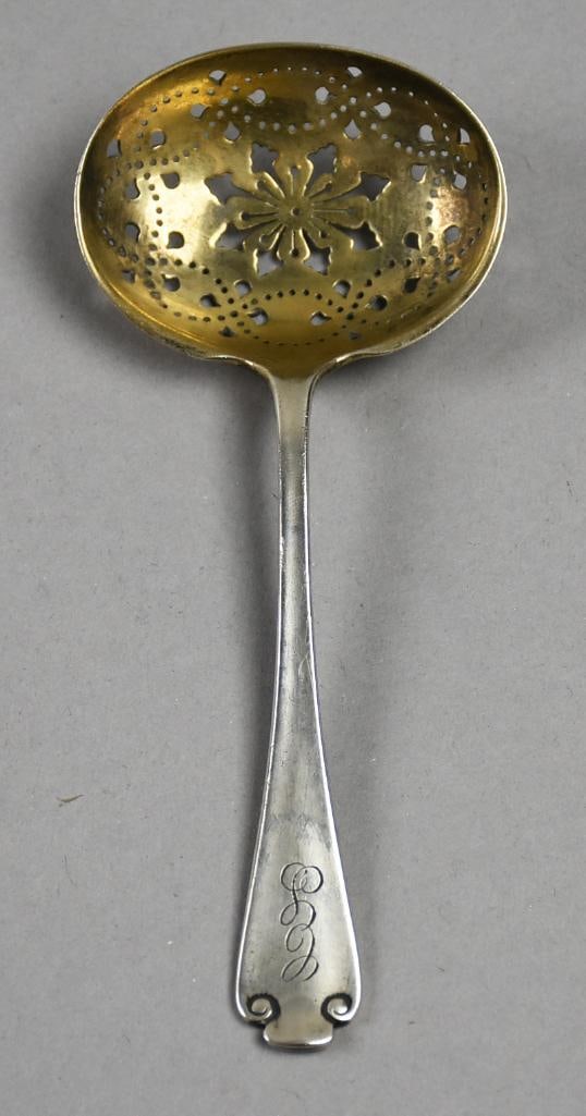 1911 Tiffany & Co Flemish Sterling Sugar Sifter, Gold Wash: Lovely piece of antique sterling from Tiffany & Co. This is in the pattern of Flemish from 1911. Reticulated bowl with gold wash. Handle end with graceful scrolls and a CS monogram. Measures approx. 5