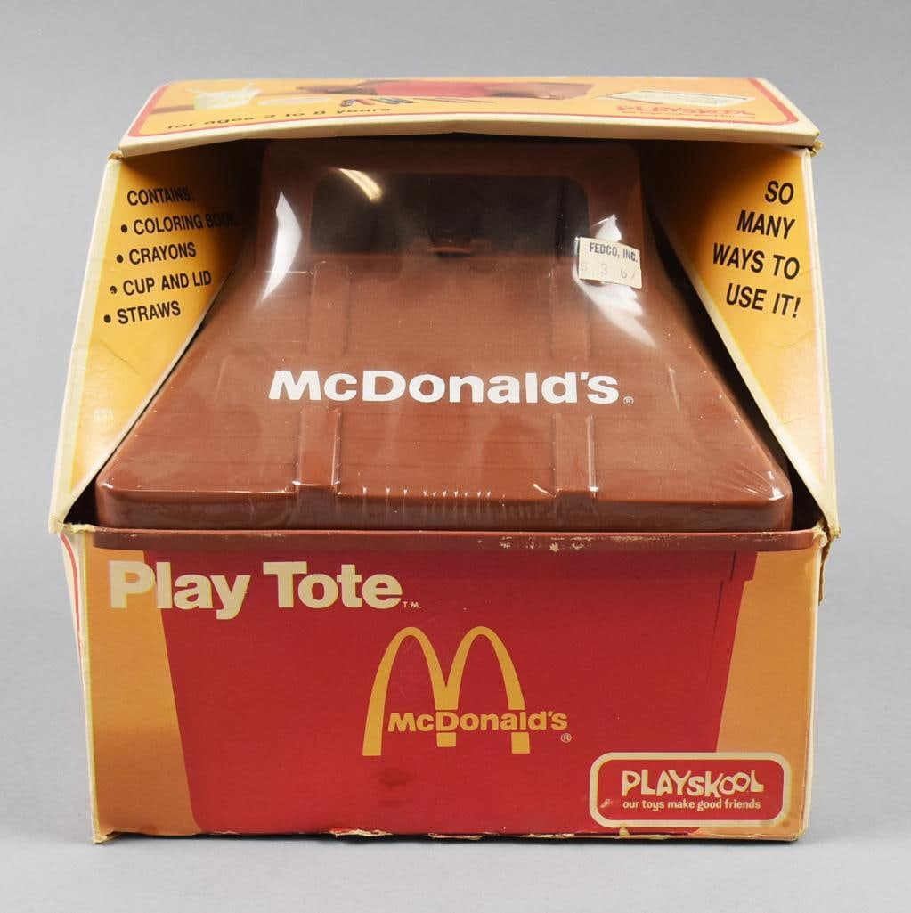 1975 McDonalds Playskool Play Tote - MIB-NOS: Cool vintage Play Tote from Playskool. This tote for McDonalds is in the form of one of the restaurants with the lid opening to show the storage. Comes in the original packaging.